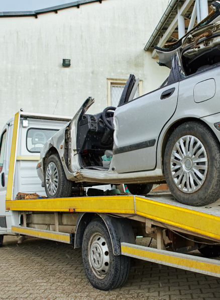 Emergency Towing - A truck towing a damaged car swiftly in response to an accident